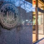 FBI Drops Hammer on Scam Empires FBI emblem on a stone wall beside a glass entrance