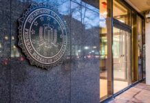 FBI Drops Hammer on Scam Empires FBI emblem on a stone wall beside a glass entrance