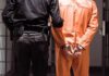 Cocaine Warlord Snatched To San Diego Prisoner in orange jumpsuit handcuffed with guard standing beside