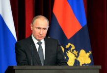 Capitol Crushes Russian Oil Lifeline man in suit speaking at a podium