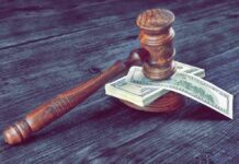 Judge's gavel resting on a stack of US dollar bills