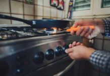Heaters Out, Panic In Person lighting a gas stove under a frying pan