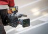 Court Smacks White House Media Purge camera operator carrying a professional video camera