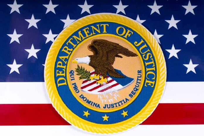 shutterstock_1054857686 Department of Justice seal on American flag background