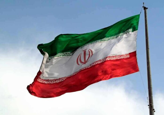 shutterstock_1088416085 Iranian flag waving on a pole