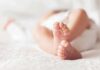 Billionaire Baby Empire Exposed baby feet on a soft white blanket