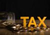 Tax Time Bomb Targets Billionaires Yellow TAX letters among coins and a tipped jar