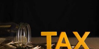 Yellow TAX letters among coins and a tipped jar