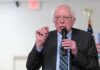 Silicon Valley Panics Over Sanders Gambit Bernie Sanders speaking into a microphone at an indoor event