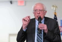 Silicon Valley Panics Over Sanders Gambit Bernie Sanders speaking into a microphone at an indoor event