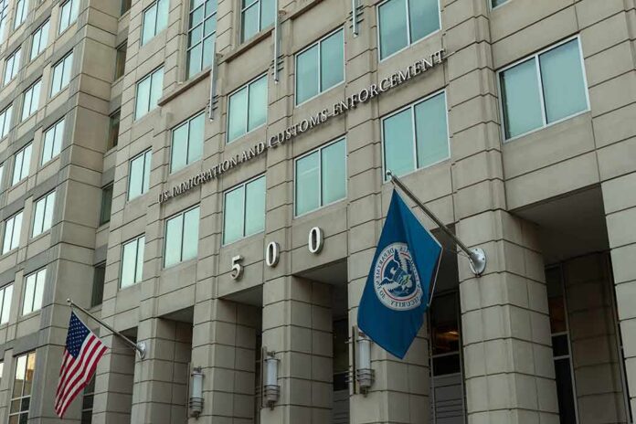 shutterstock_1485768215-2 U.S. government building facade with American and blue departmental flags