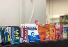 Trusted Painkiller, Hidden Danger Over-the-counter medicine boxes on a store shelf