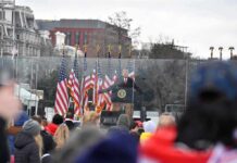 Trump Heads To UN With Iran In Focus speaker at presidential podium addressing crowd outdoors