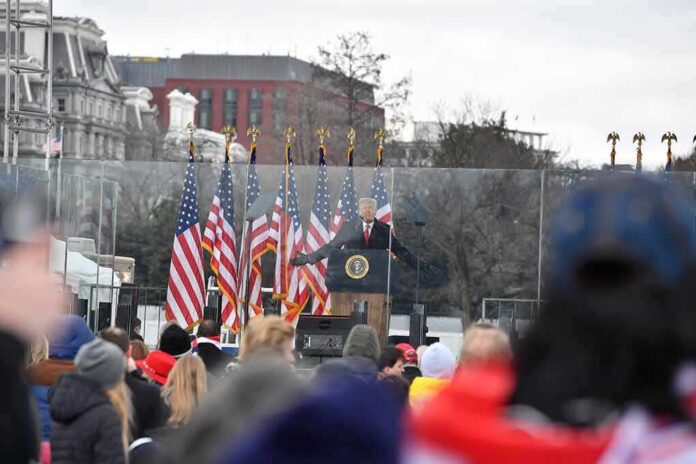 speaker at presidential podium addressing crowd outdoors