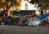 Rat-Borne Illness Raises Stakes In Berkeley Street encampment with tarps and makeshift tents by roadside