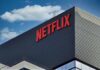 Netflix Tycoon Drops $1M Bomb Netflix logo on modern office building exterior
