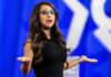 $200,000 Mystery Shadows Congressman Woman speaking on stage with arms outstretched