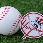 Baseball and team logo sticker on grass