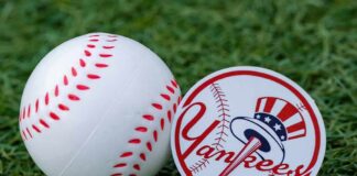 Baseball and team logo sticker on grass