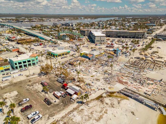 shutterstock_2208987255 Aerial view of coastal town with widespread storm damage