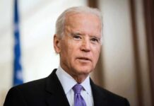 Biden Honors Spark Outrage Blitz Joe Biden in a suit and purple tie speaking indoors