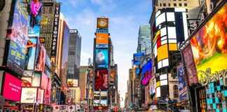 Times Square street with yellow taxis and bright billboards