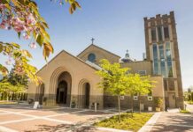 Talarico’s Church in Hot Water Brick church with arched entrance and tall bell tower on a sunny day