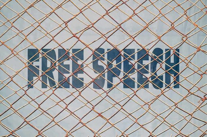 shutterstock_277161200 Rusty chain-link fence over bold text on a wall