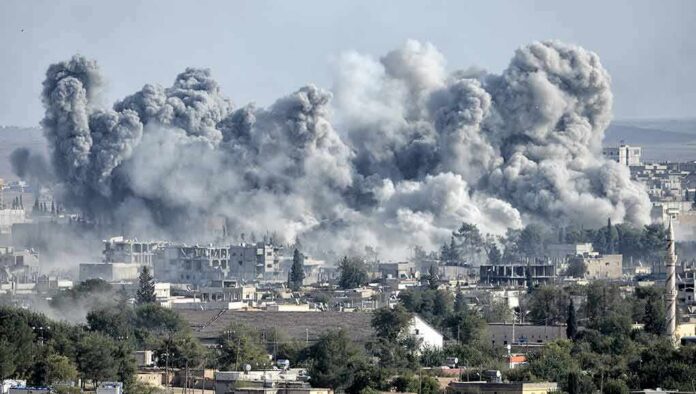 shutterstock_325363238 Massive smoke plumes rise over a city after explosions