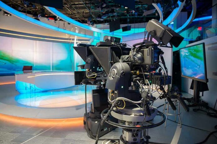 robotic television cameras on a modern news studio set