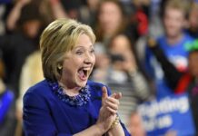 Clinton Raises A Startling Netanyahu Question Smiling woman in blue clapping at an event