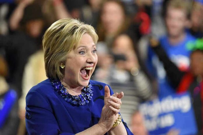 Smiling woman in blue clapping at an event