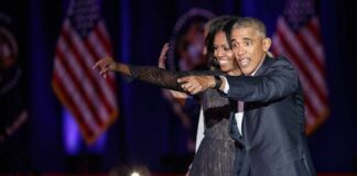 Michelle Obama and Rob Nabors pointing on stage at an event