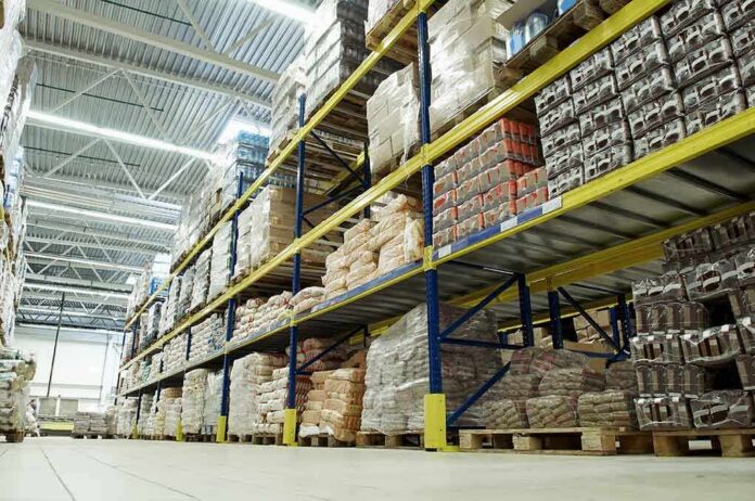 Interior view of a warehouse with stacked shelves of packaged goods