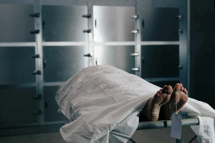 shutterstock_761982997 Body on a morgue gurney with toe tag