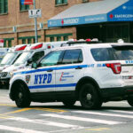 Grim Drive Ends In Chilling Admission Police car and ambulances outside emergency room entrance.