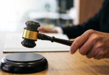 Judge Hammers Ex-Congressman Judge's hand holding a gavel over a sound block