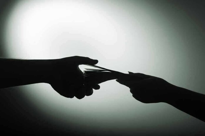 hands exchanging cash