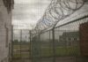 Rikers Shower Slip Triggers $1M Fight Barbed wire on chain-link fence at a prison yard