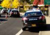 Felony Heat After Car Targets Journalist Police cars with lights on near school buses on a city street