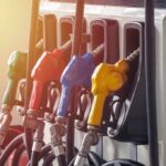 Fuel Tax Holiday – Trump Drops The Hammer Fuel pump nozzles in multiple colors at a gas station