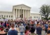 2 A.M. Horror Stuns Congressional Bid David Givens at a large protest outside a neoclassical courthouse