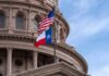 Credible Threat Triggers Overnight Raid Texas and U.S. flags in front of a capitol building dome