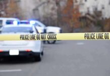 Attempted Murder Avalanche Hits Teen Police tape cordons off a street with patrol cars and flashing lights in the background