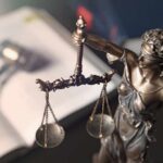 107,000 Texts Expose a Dark Plot Lady Justice statue holding balanced scales
