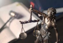107,000 Texts Expose a Dark Plot Lady Justice statue holding balanced scales