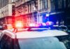 Midnight Balcony Push Rocks City Police car with flashing lights in city street