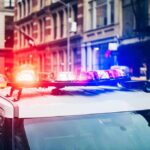 Police car with flashing lights in city street