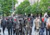 Nearly 400 Schools Go Dark group of masked protesters walking through a city street
