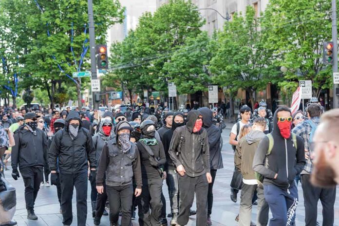 group of masked protesters walking through a city street